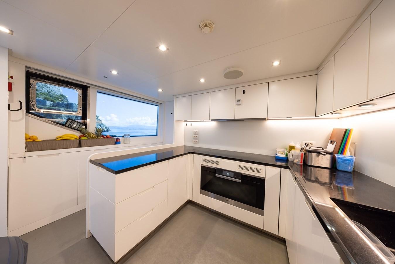 a kitchen with a large window aboard ZULU 3 Yacht for Sale