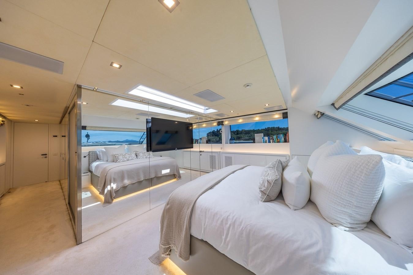 a room with beds and a tv aboard ZULU 3 Yacht for Sale