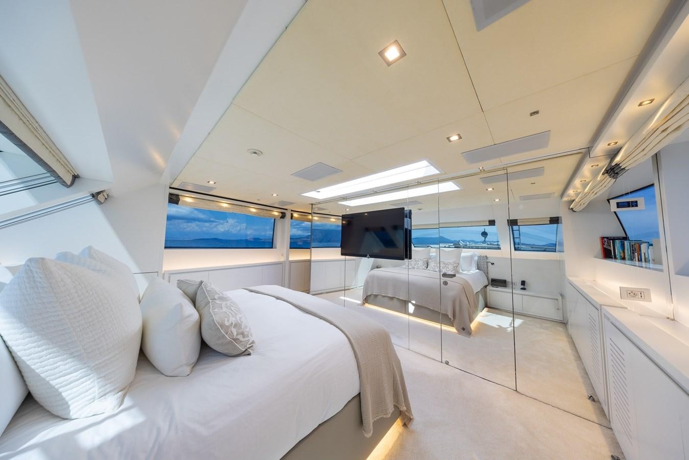 a room with beds and a tv aboard ZULU 3 Yacht for Sale