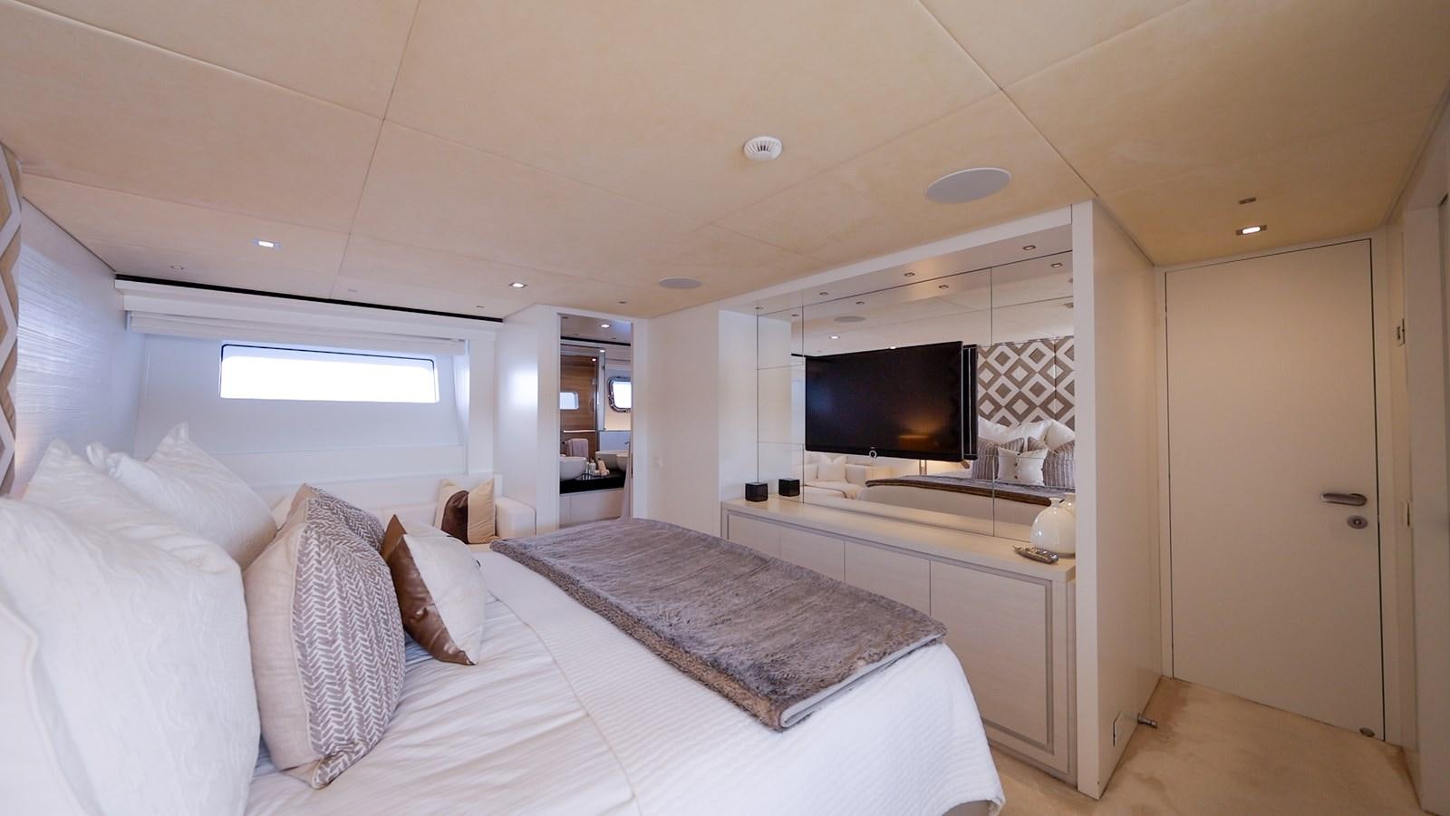 a bedroom with a bed and a tv aboard ZULU 3 Yacht for Sale