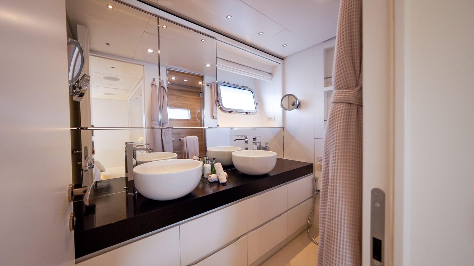 a bathroom with sinks and mirrors aboard ZULU 3 Yacht for Sale