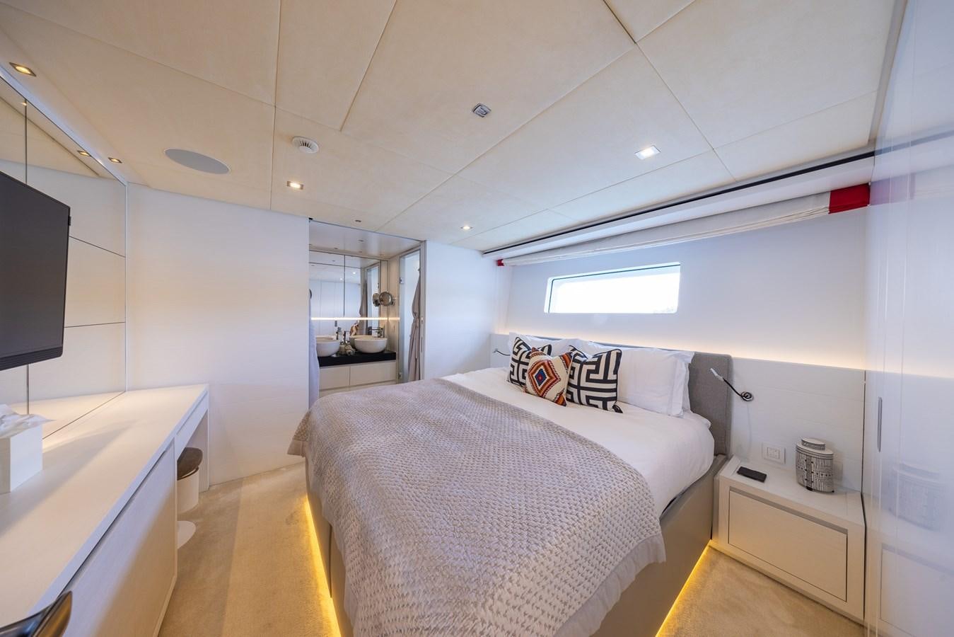 a bedroom with a bed and a tv aboard ZULU 3 Yacht for Sale
