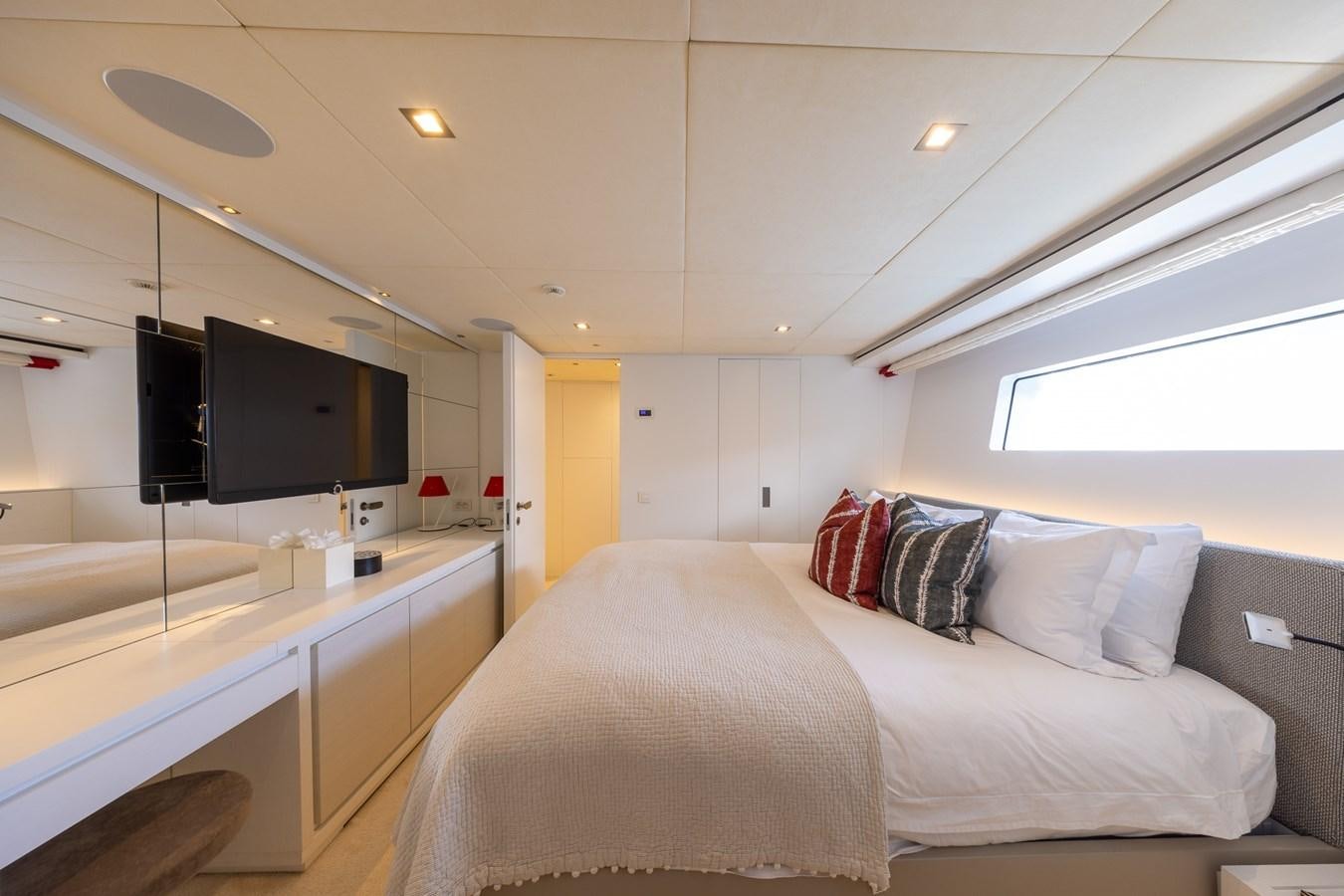 a bedroom with a bed and a tv aboard ZULU 3 Yacht for Sale