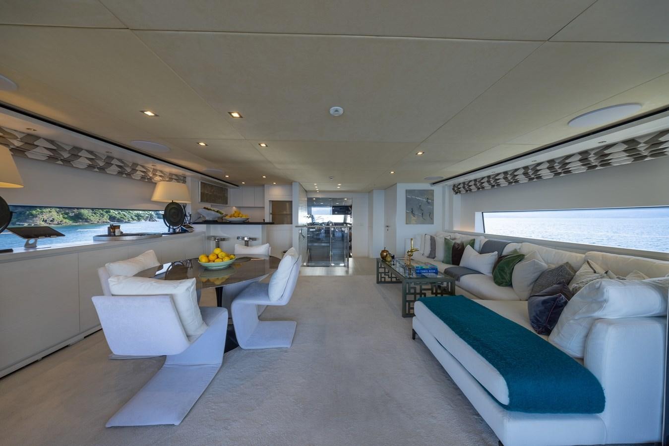 a living room with white furniture aboard ZULU 3 Yacht for Sale