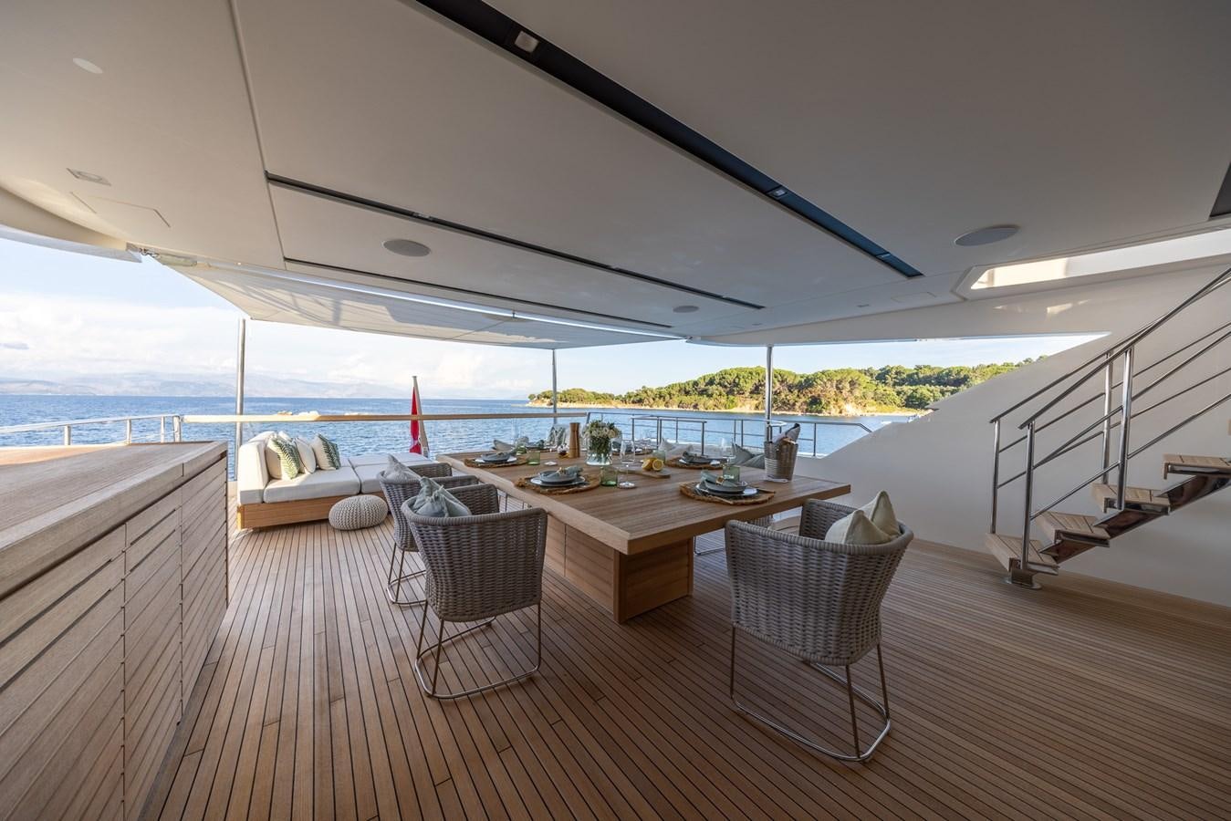 a table and chairs on a deck aboard ZULU 3 Yacht for Sale