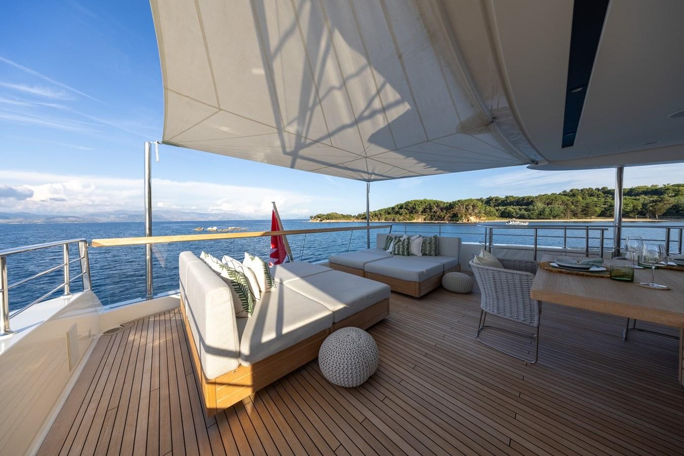 a deck with a table and chairs on it aboard ZULU 3 Yacht for Sale