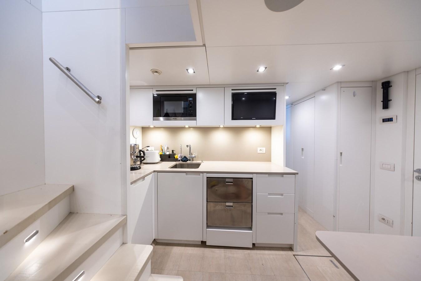 a kitchen with white cabinets aboard ZULU 3 Yacht for Sale