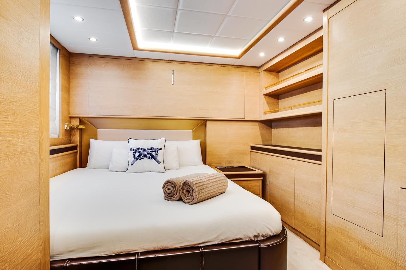 a bed with a white comforter aboard GRACE Yacht for Sale