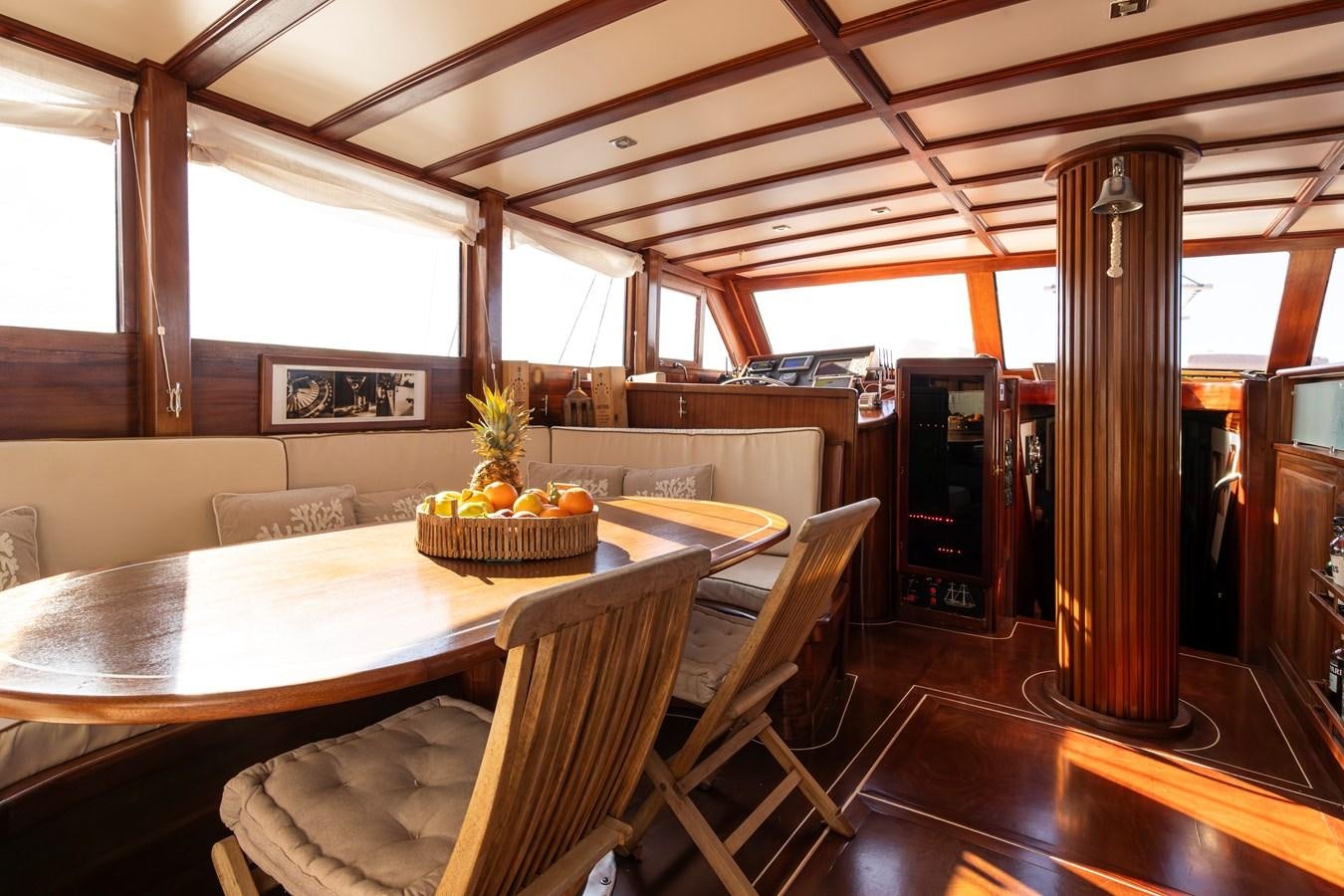 a room with a table and chairs aboard DAI Yacht for Sale