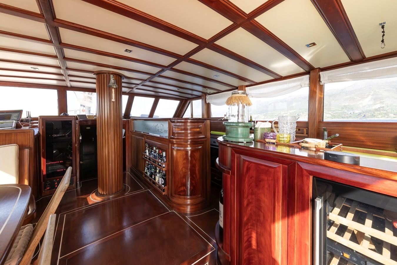 a kitchen with wooden cabinets aboard DAI Yacht for Sale