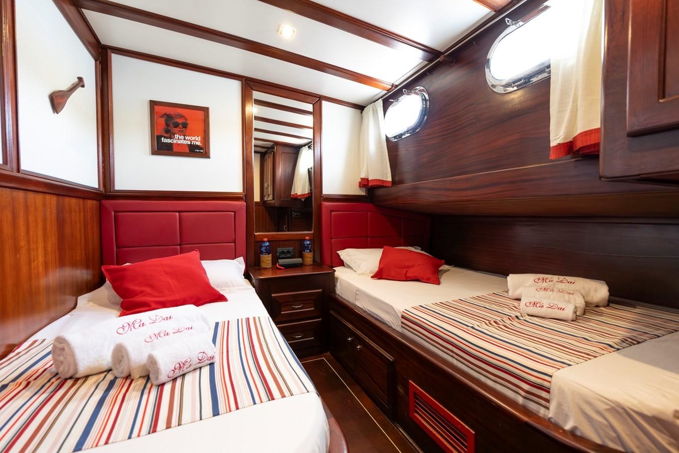 a room with two beds aboard DAI Yacht for Sale