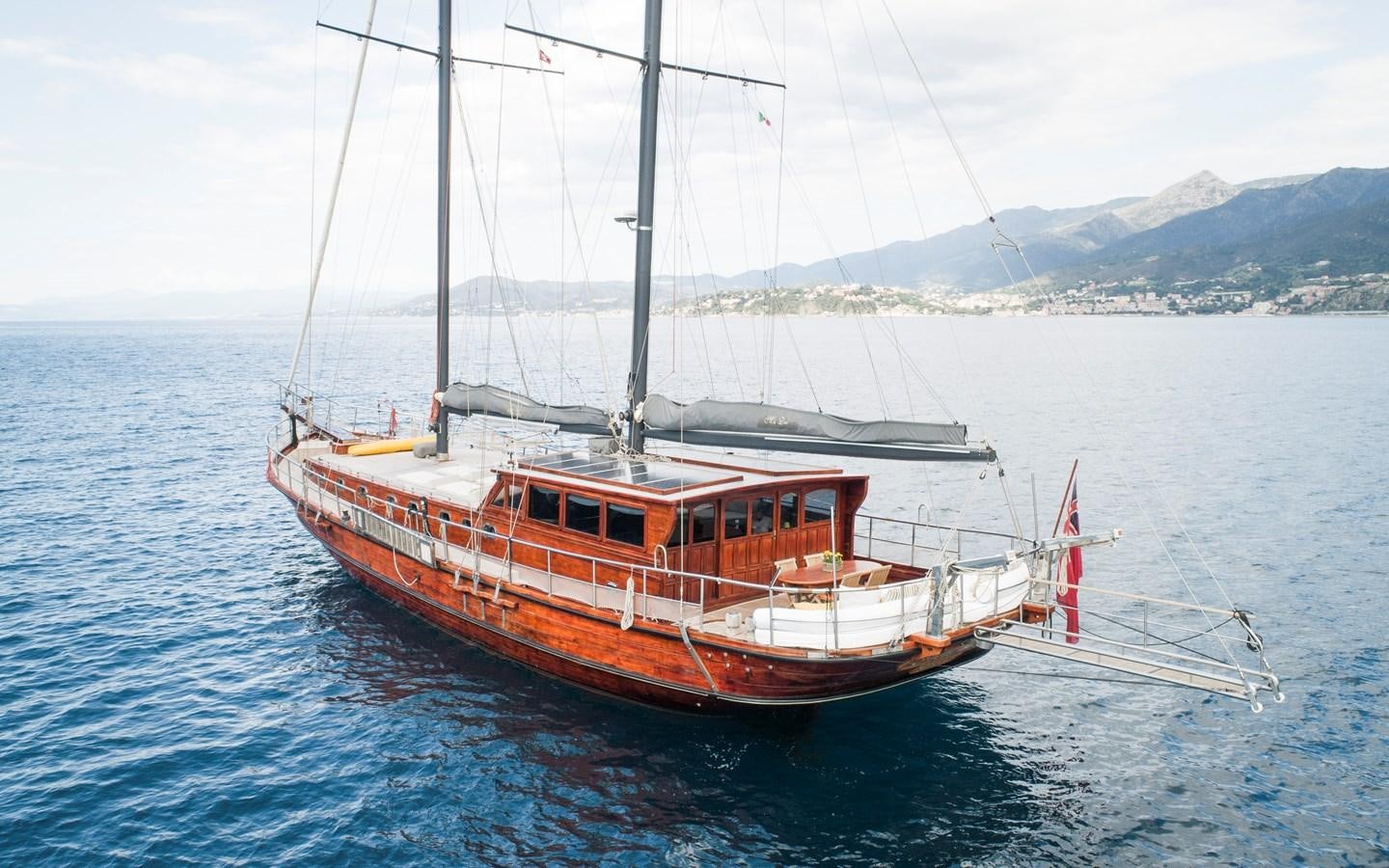 a red and white boat in the water aboard DAI Yacht for Sale