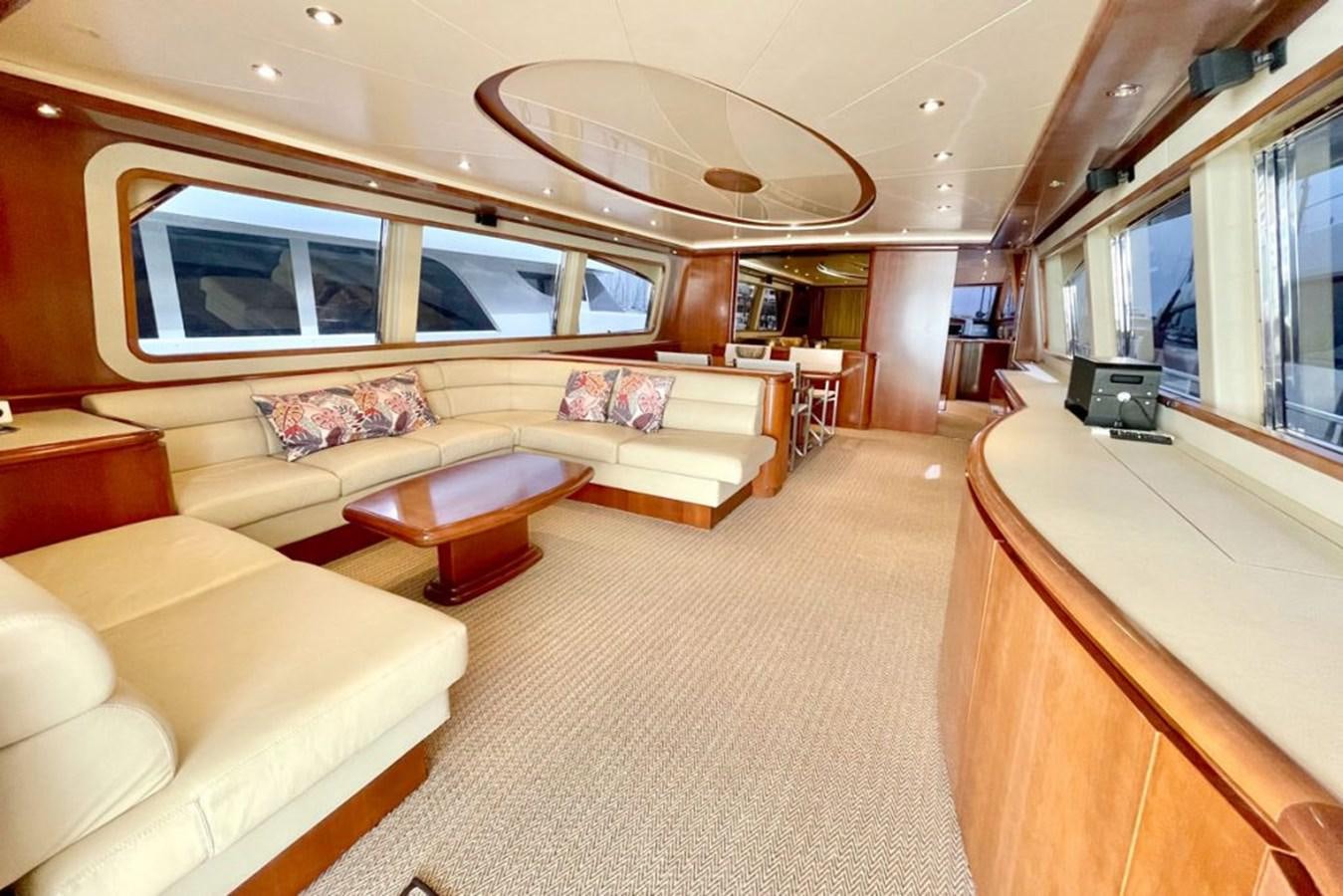 a living room with a large chandelier aboard VIDA LOCA Yacht for Sale