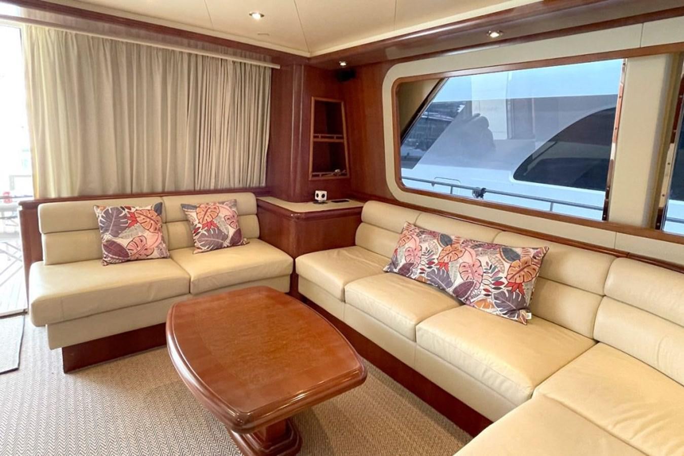 a living room with a couch and a tv aboard VIDA LOCA Yacht for Sale