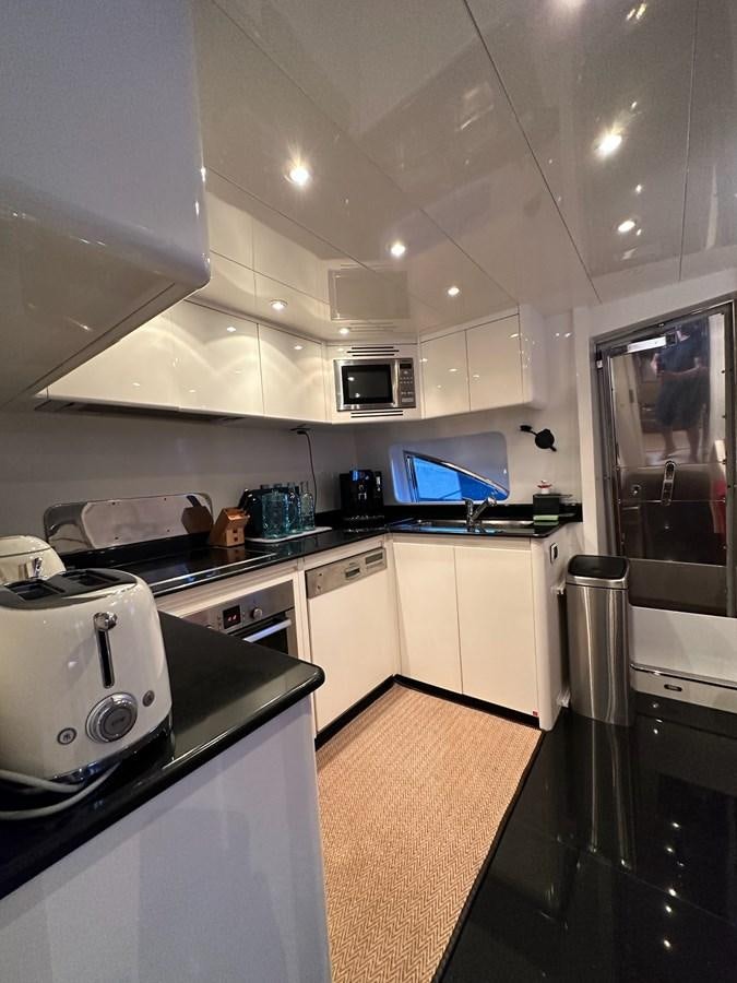 a kitchen with white cabinets aboard VIDA LOCA Yacht for Sale