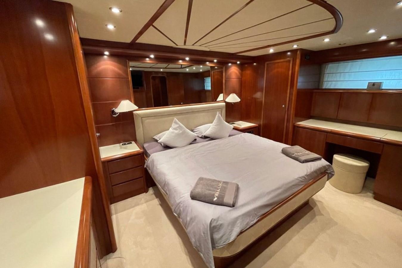 a room with a bed and a desk aboard VIDA LOCA Yacht for Sale