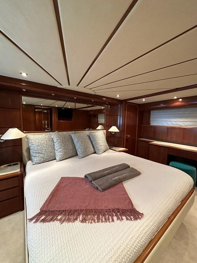 a bed with a pink blanket aboard VIDA LOCA Yacht for Sale