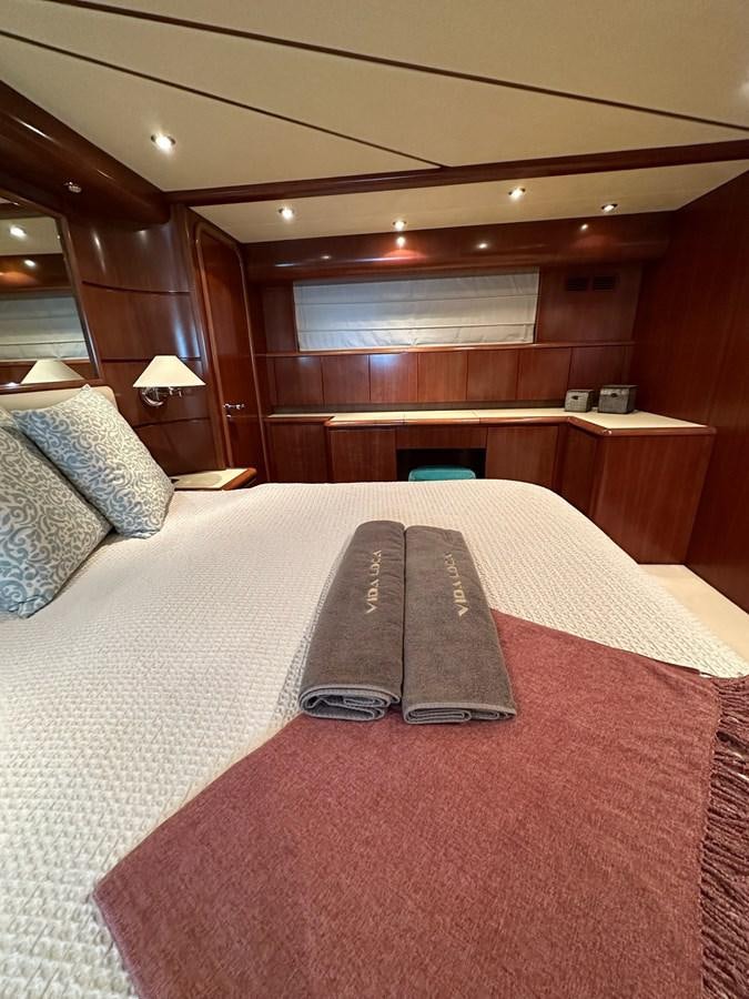 a bed with a red and white bed spread aboard VIDA LOCA Yacht for Sale