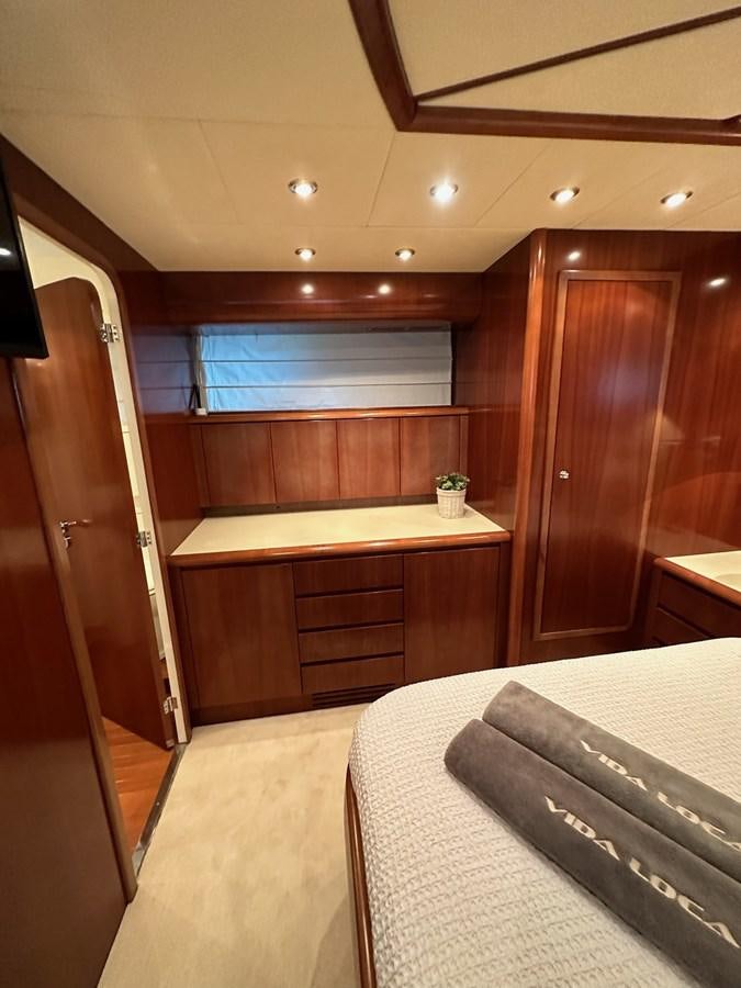 a room with a bed and a desk aboard VIDA LOCA Yacht for Sale