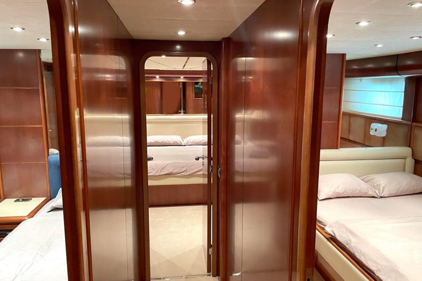 a room with a bed and a closet aboard VIDA LOCA Yacht for Sale