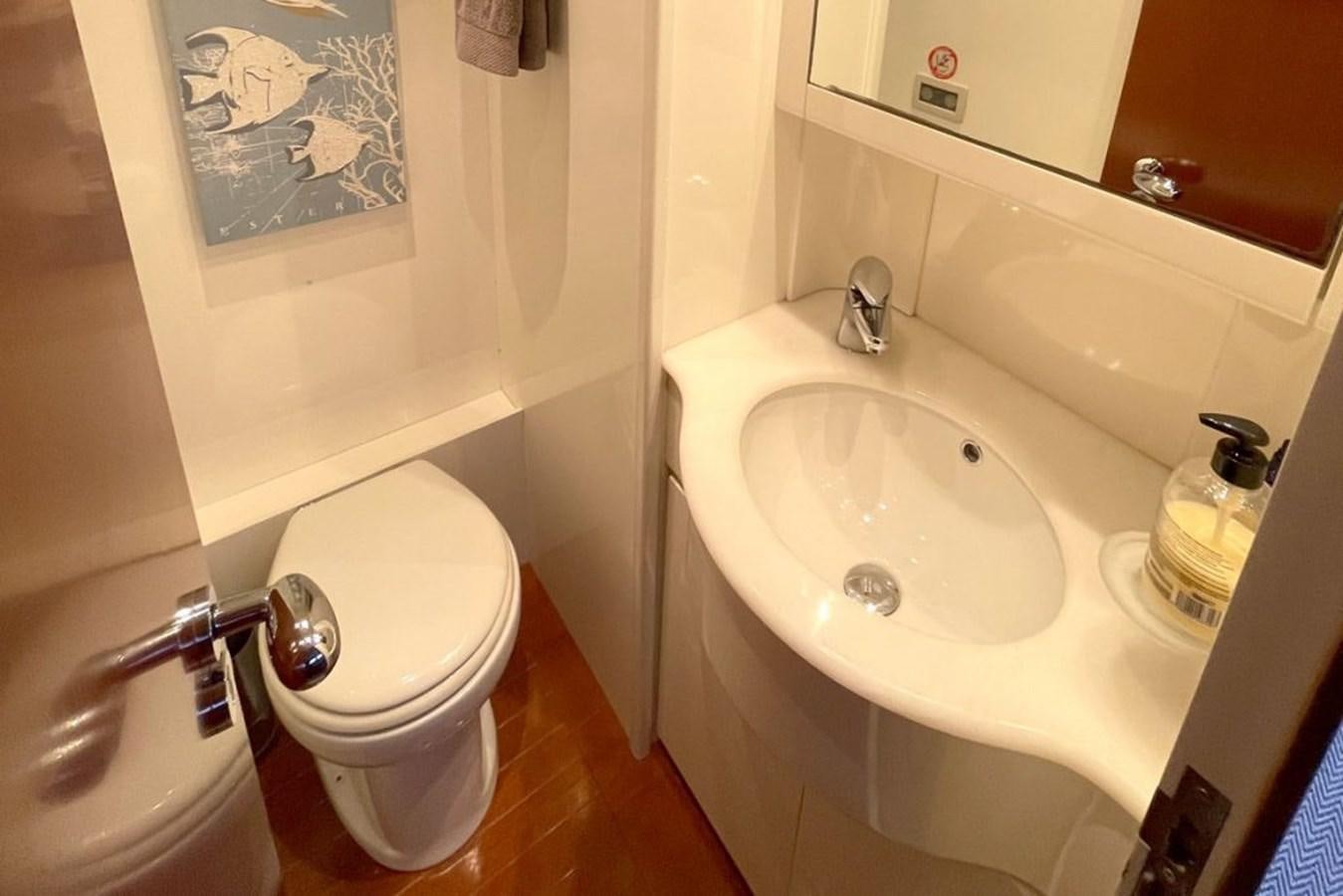 a bathroom with a toilet and sink aboard VIDA LOCA Yacht for Sale