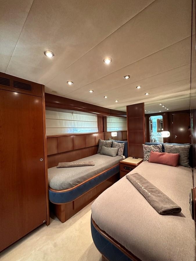 a room with a bed and a couch aboard VIDA LOCA Yacht for Sale
