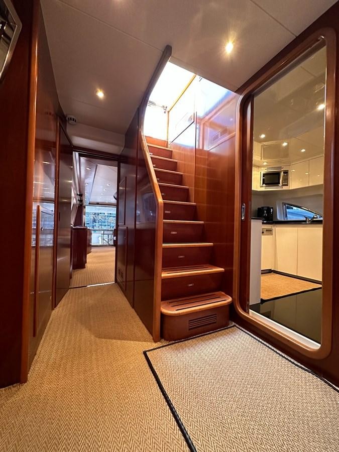 a room with a wood door and a glass wall with doors aboard VIDA LOCA Yacht for Sale