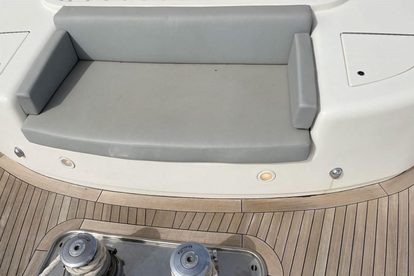 a white rectangular object on a wooden surface aboard VIDA LOCA Yacht for Sale