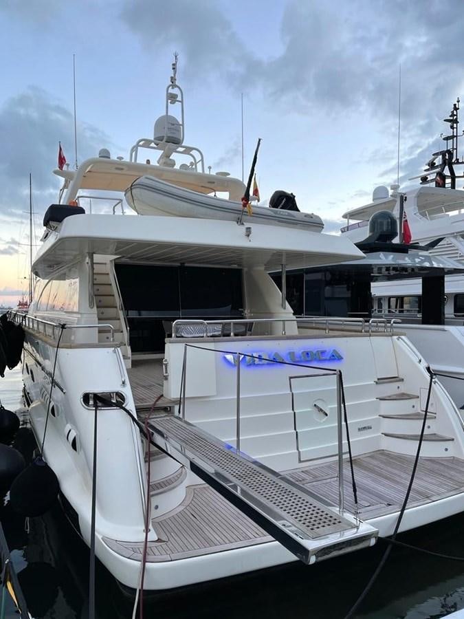 a boat with a flag on the front aboard VIDA LOCA Yacht for Sale