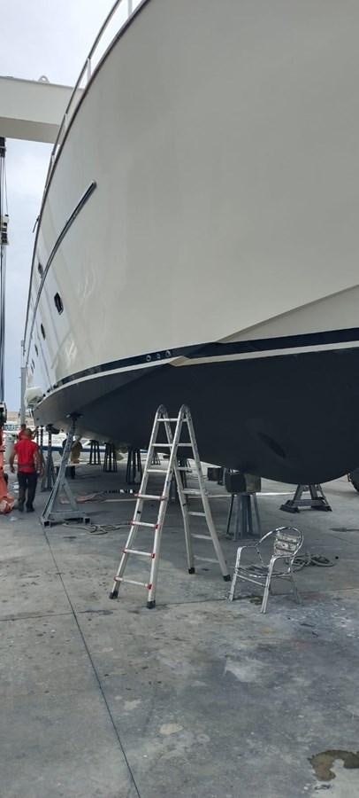 a large white boat with a ladder aboard VIDA LOCA Yacht for Sale