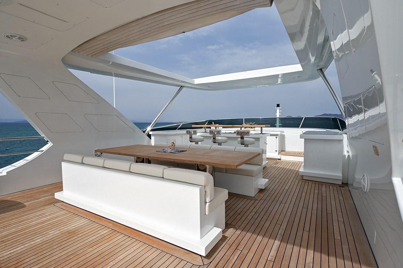a room with a table and a bed aboard FREEDAY Yacht for Sale