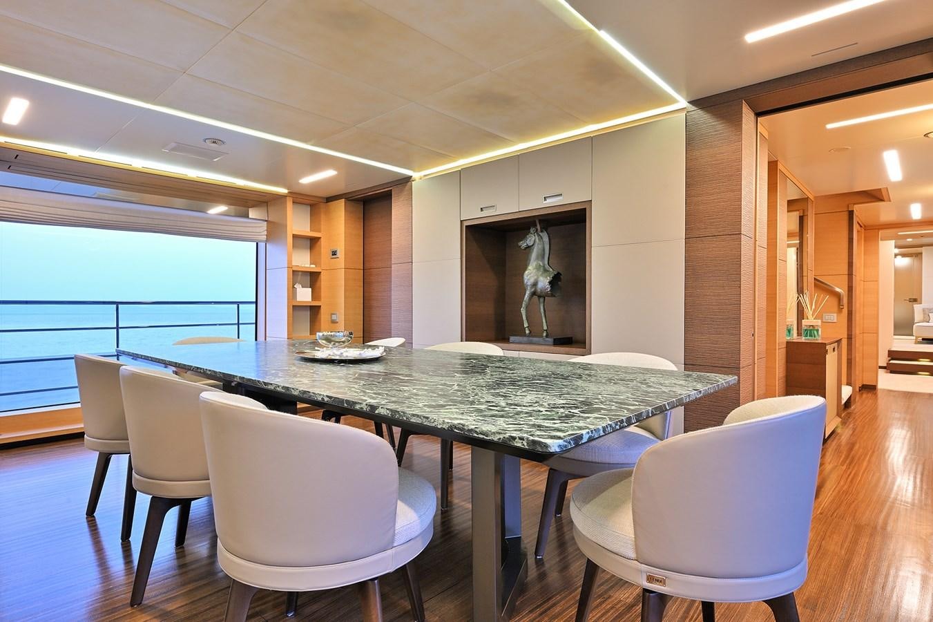a large dining table with chairs around it aboard FREEDAY Yacht for Sale