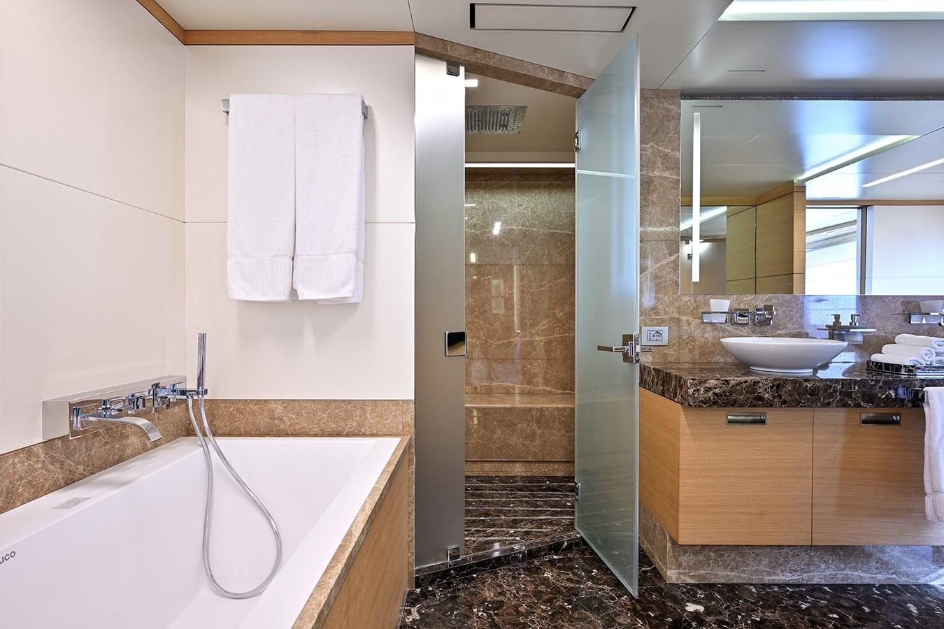 a bathroom with a tub sink and a sink aboard FREEDAY Yacht for Sale