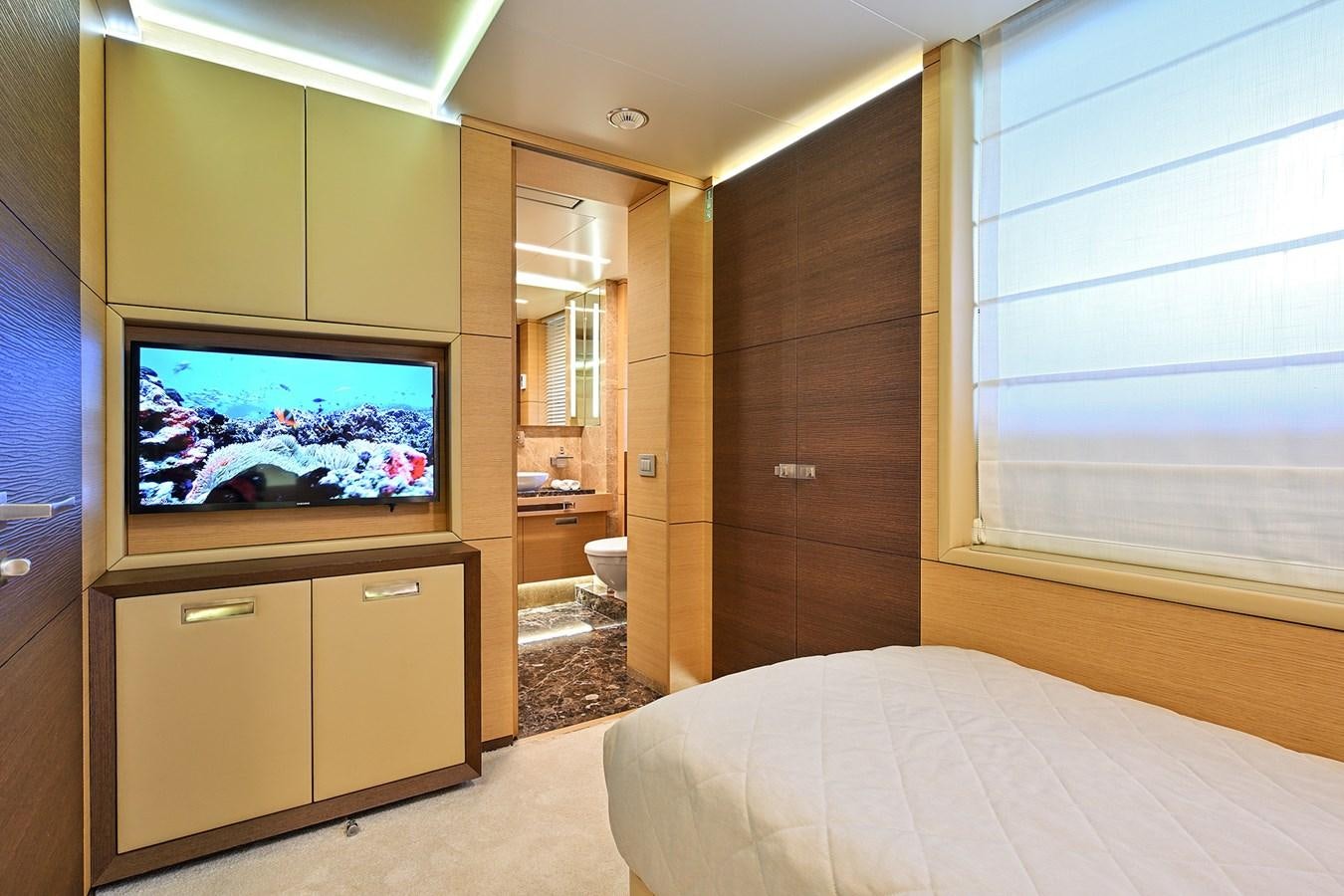 a bedroom with a bed and a television aboard FREEDAY Yacht for Sale