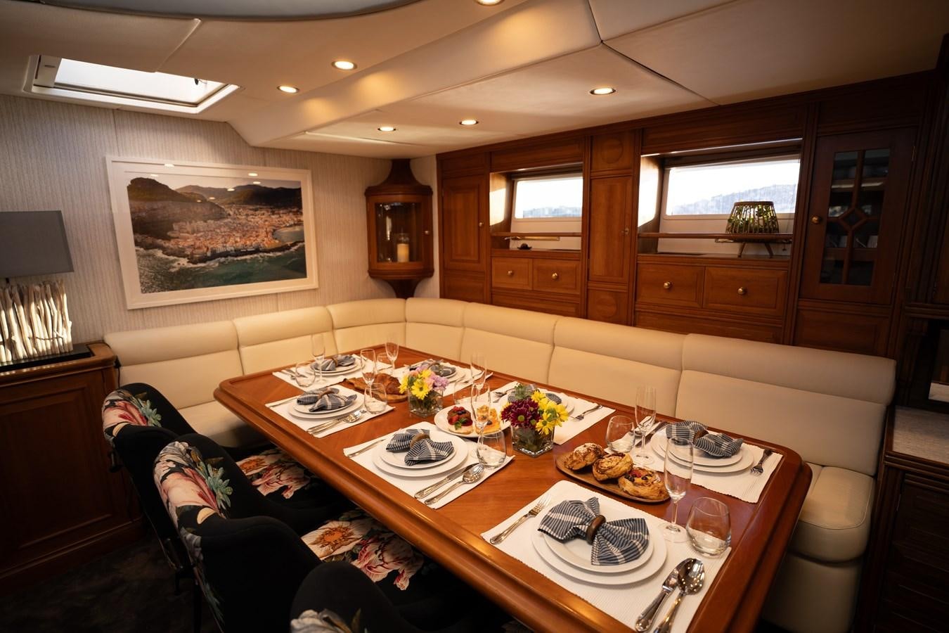 a dining room with a table set aboard YQUEM Yacht for Sale