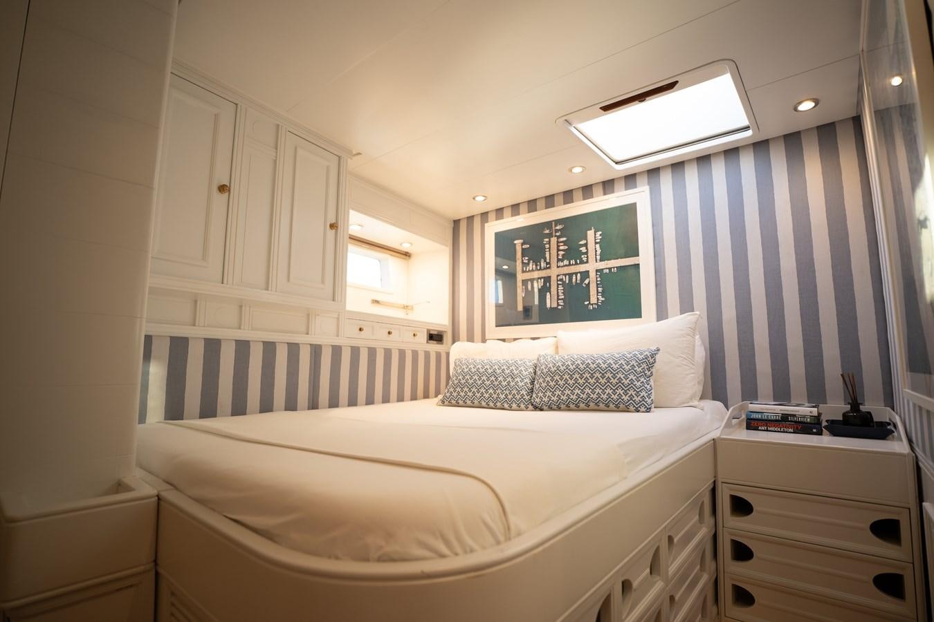 a bedroom with a bed and a window aboard YQUEM Yacht for Sale