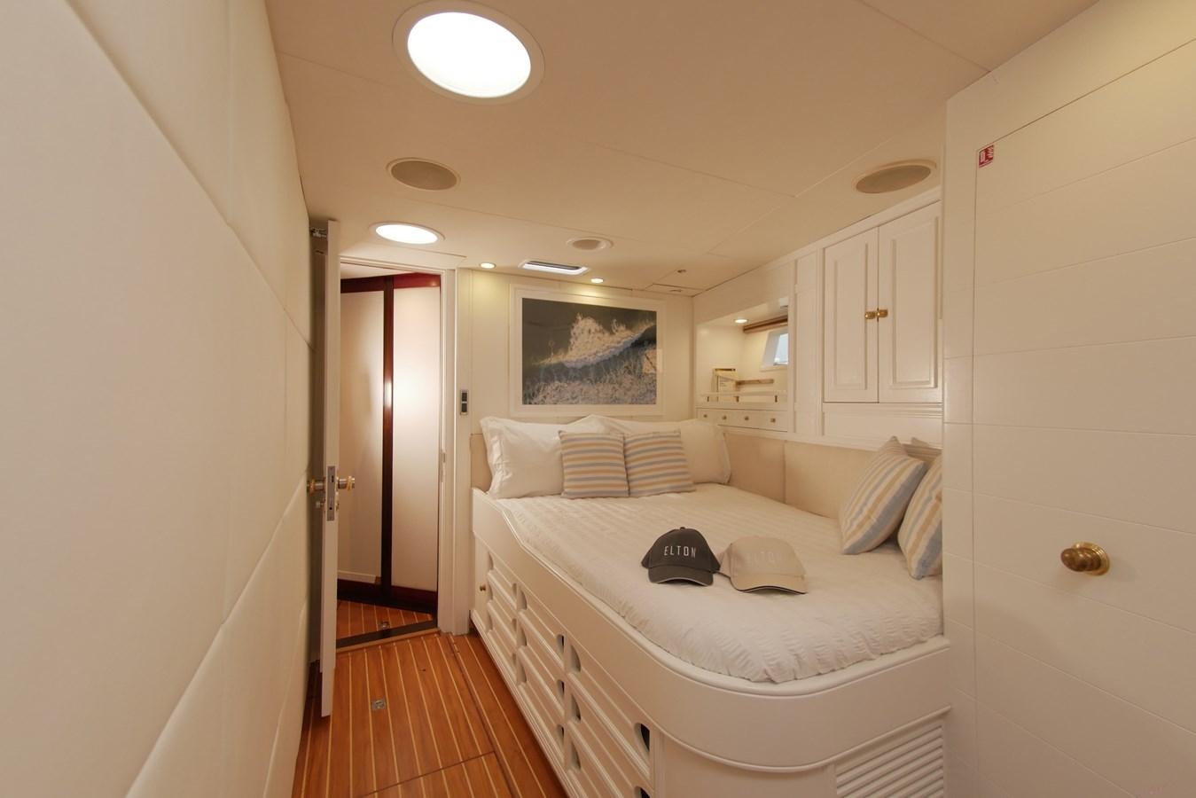 a bedroom with a bed and a desk aboard YQUEM Yacht for Sale