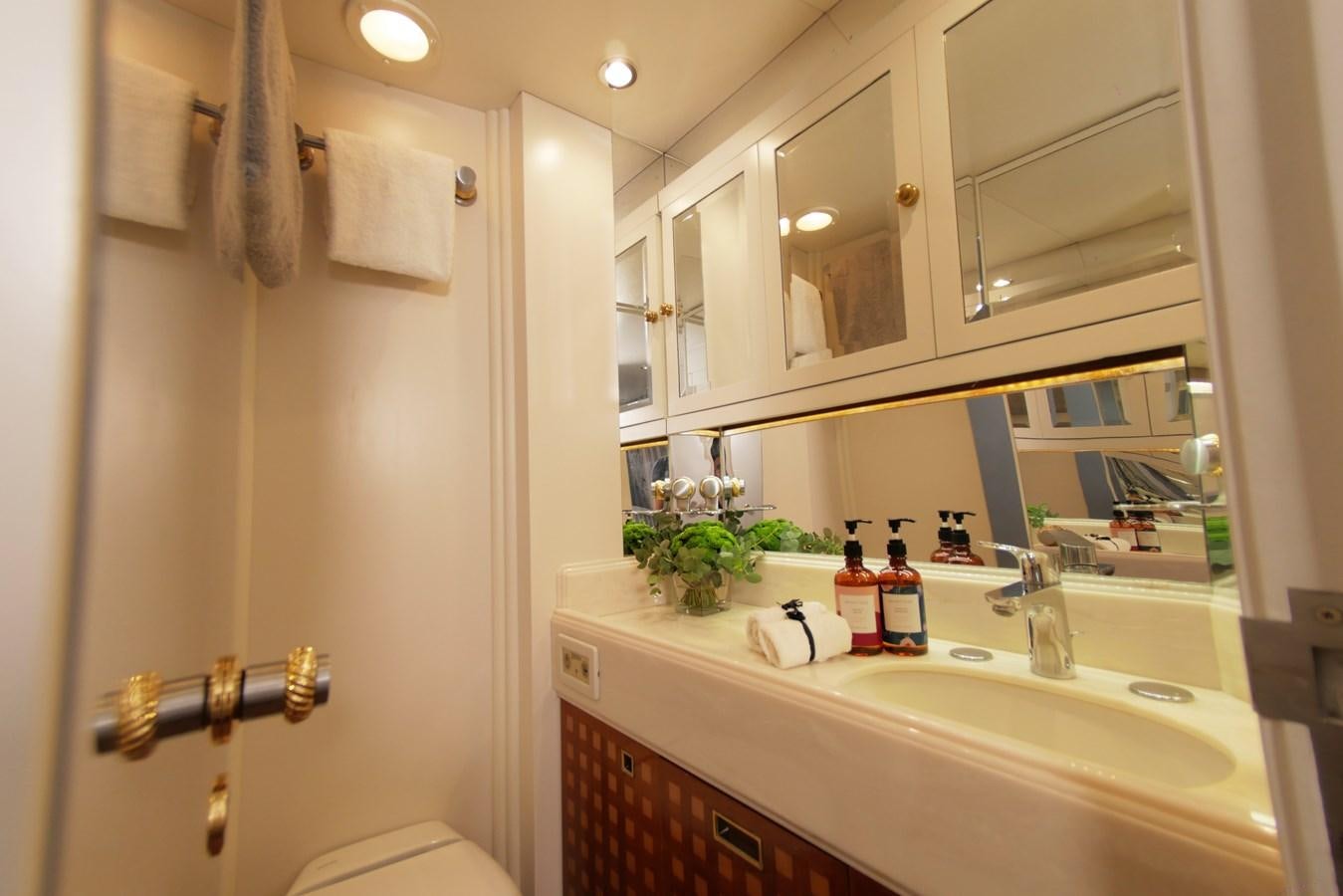 a bathroom with a sink and mirror aboard YQUEM Yacht for Sale