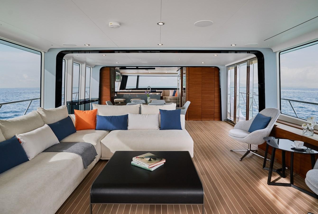 a living room with a couch and a table aboard CLX96/01 Yacht for Sale