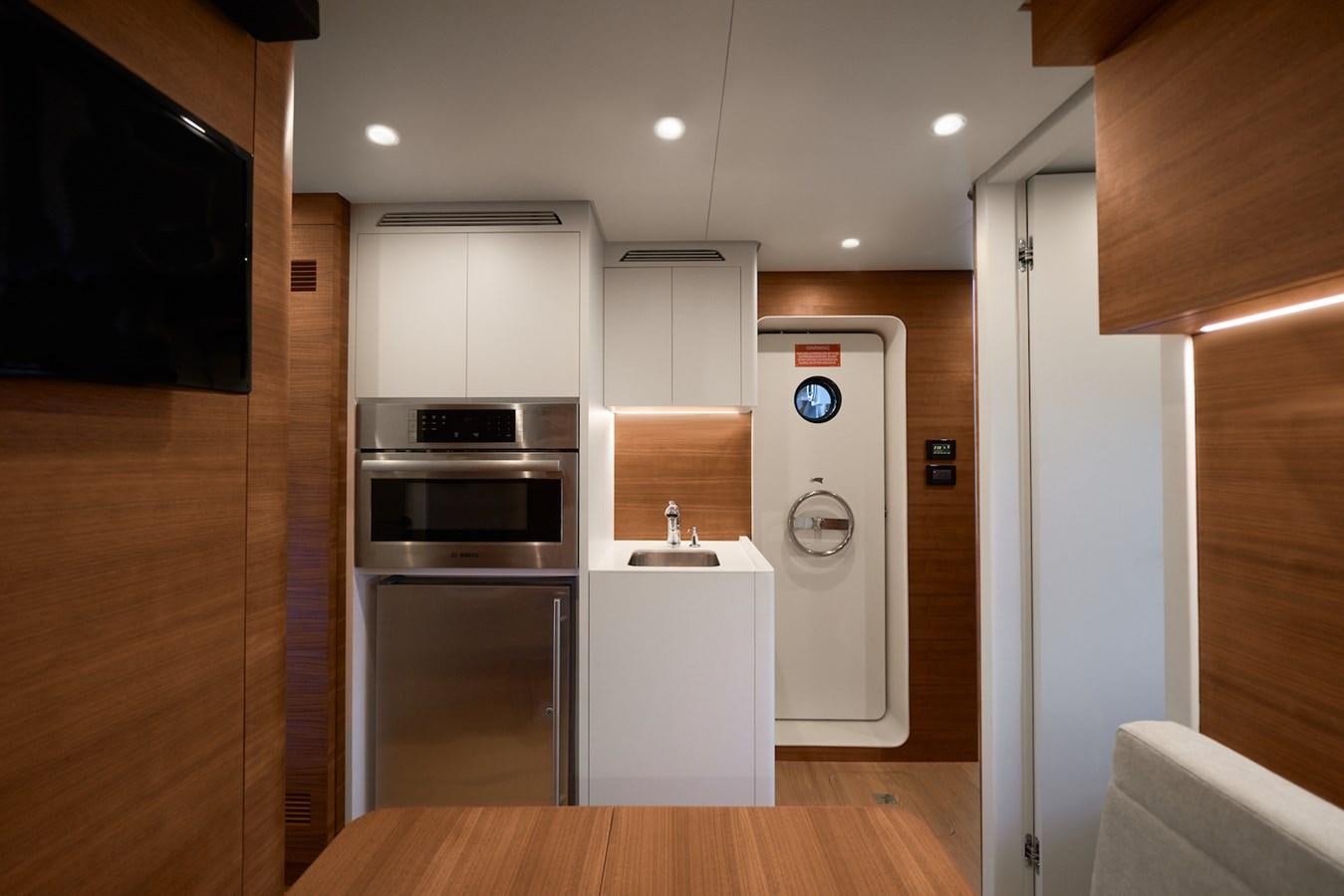 a kitchen with white cabinets aboard CLX96/01 Yacht for Sale