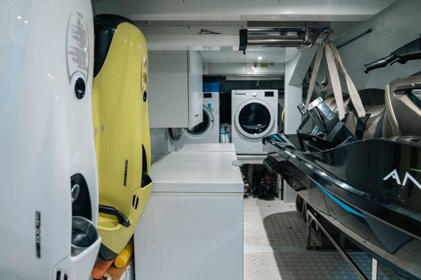a yellow surfboard next to a white machine aboard ANGELS Yacht for Sale