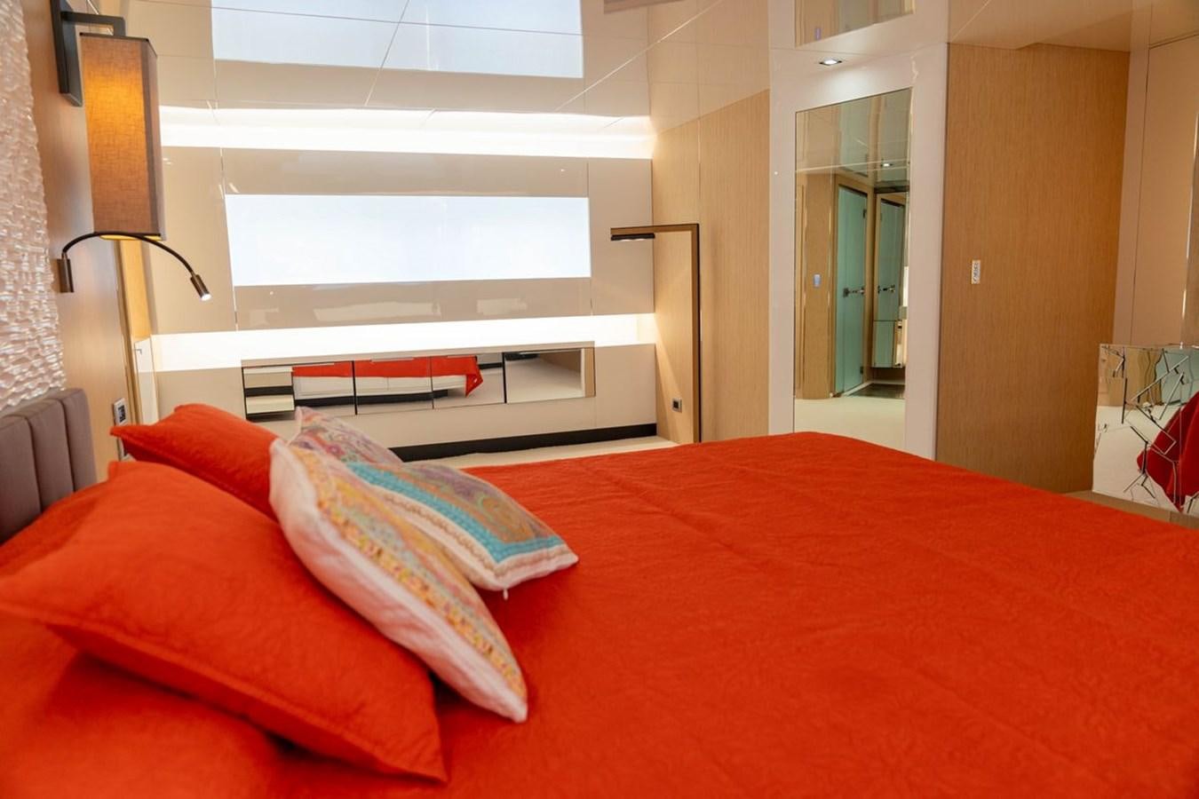 a bed with orange sheets aboard ANGELS Yacht for Sale