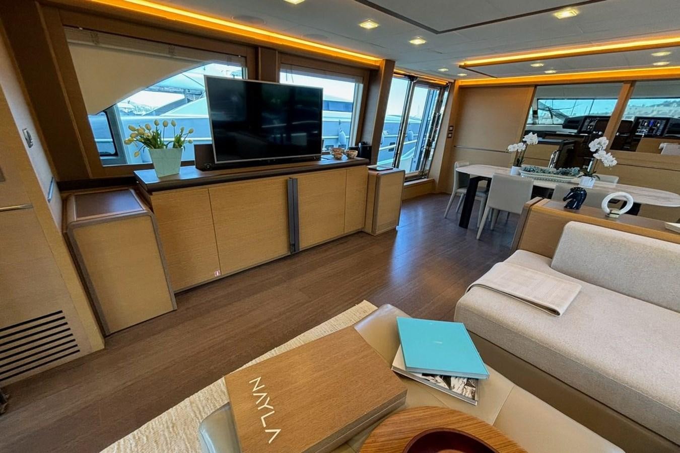 a living room with a tv and furniture aboard NAYLA Yacht for Sale
