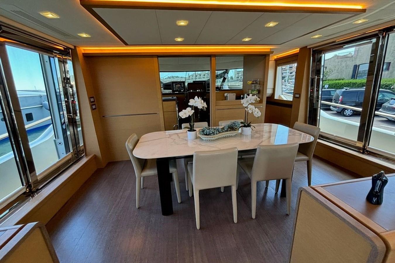 a table with chairs around it aboard NAYLA Yacht for Sale