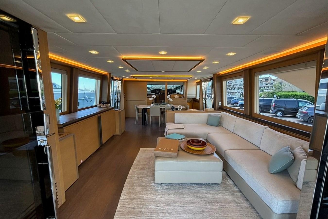a living room with a couch and a table aboard NAYLA Yacht for Sale