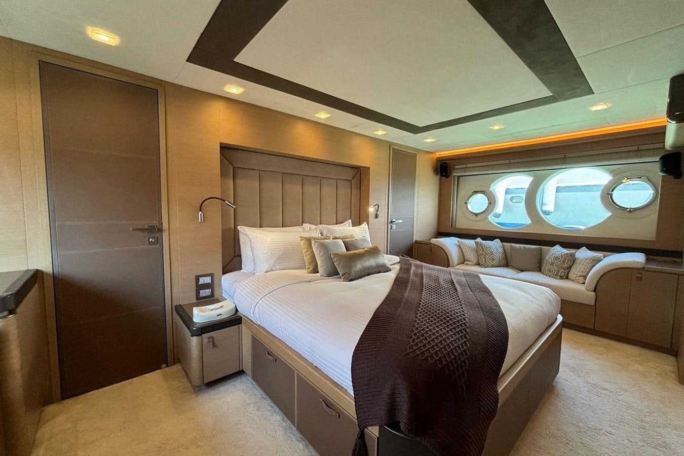 a bedroom with a bed and a mirror aboard NAYLA Yacht for Sale