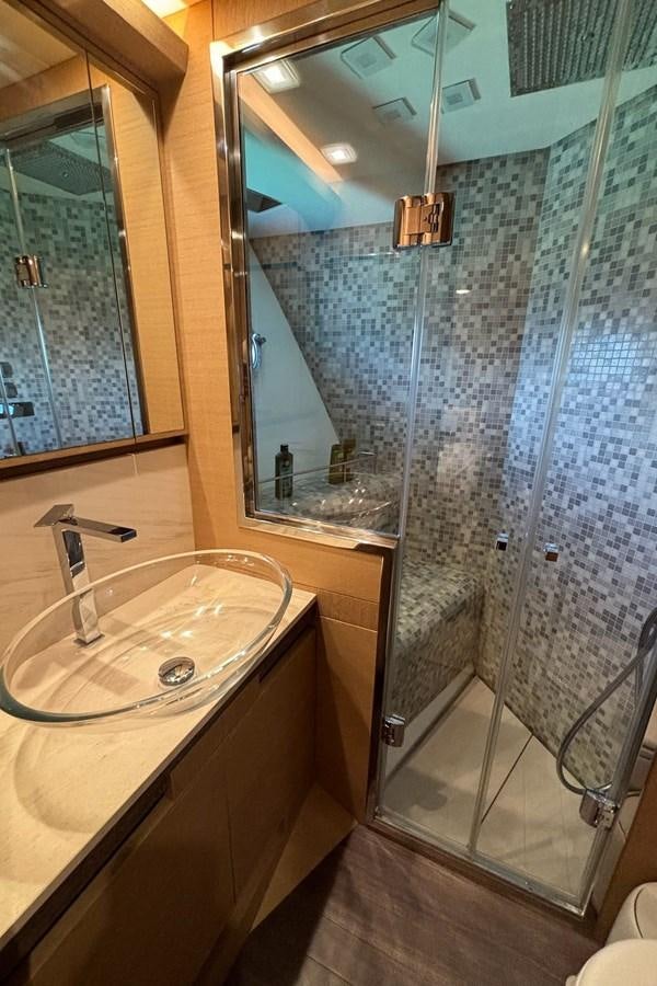 a bathroom with a glass shower aboard NAYLA Yacht for Sale