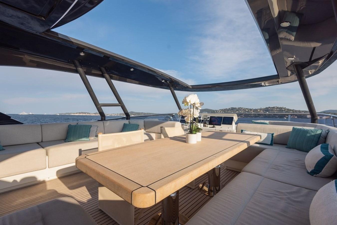 a room with a table and chairs aboard NAYLA Yacht for Sale