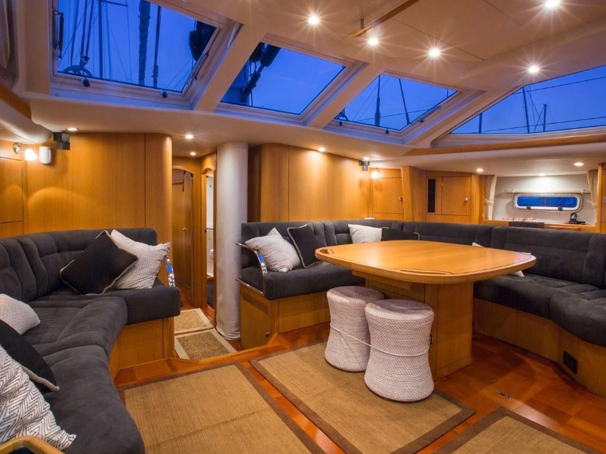 a living room with a couch and a table aboard MATAWAI Yacht for Sale