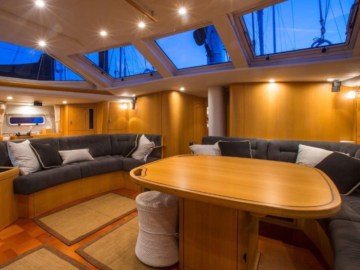 a living room with a couch and a table aboard MATAWAI Yacht for Sale